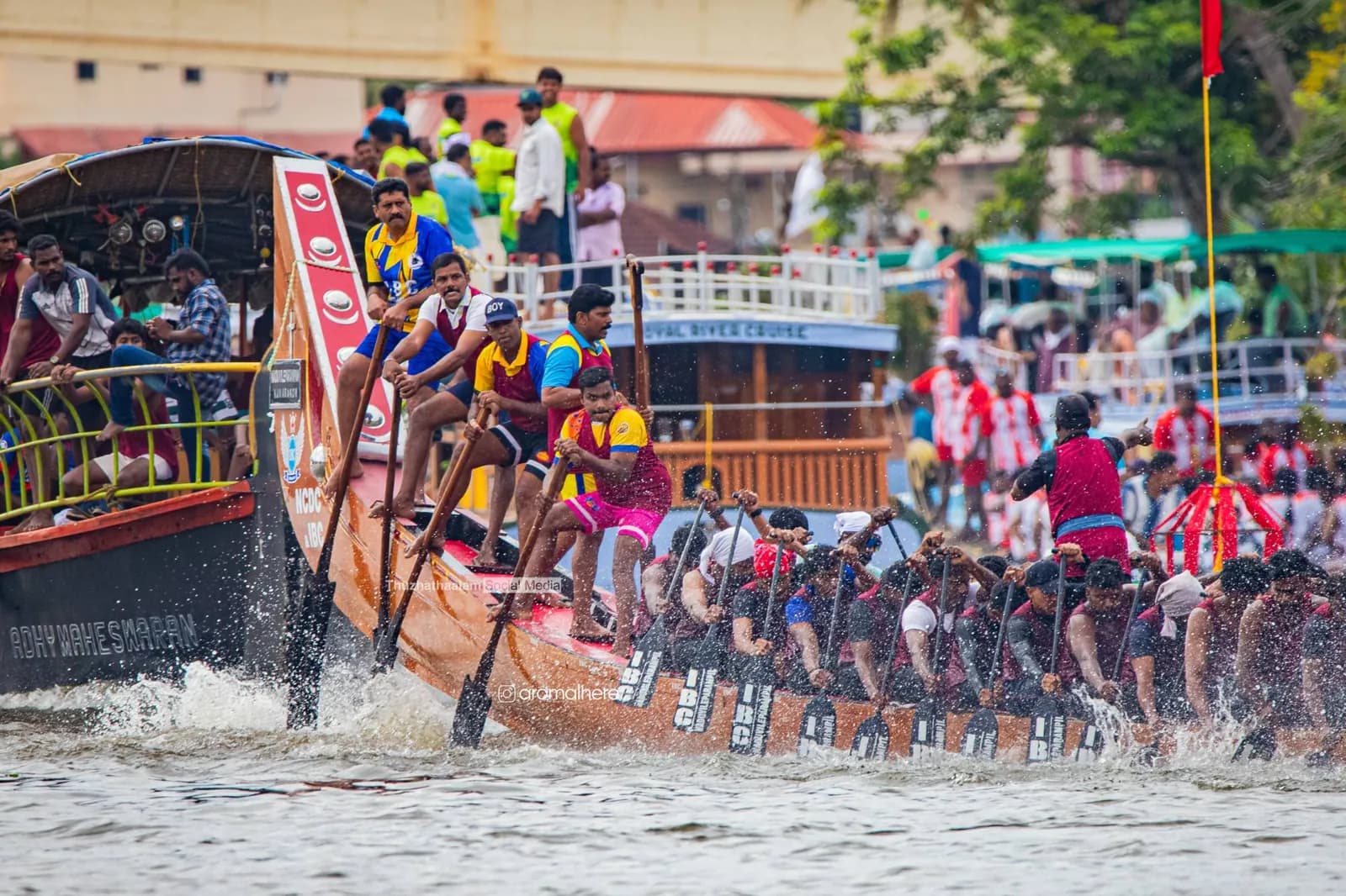 IBC crew and steersmen powering past a houseboat full of fans