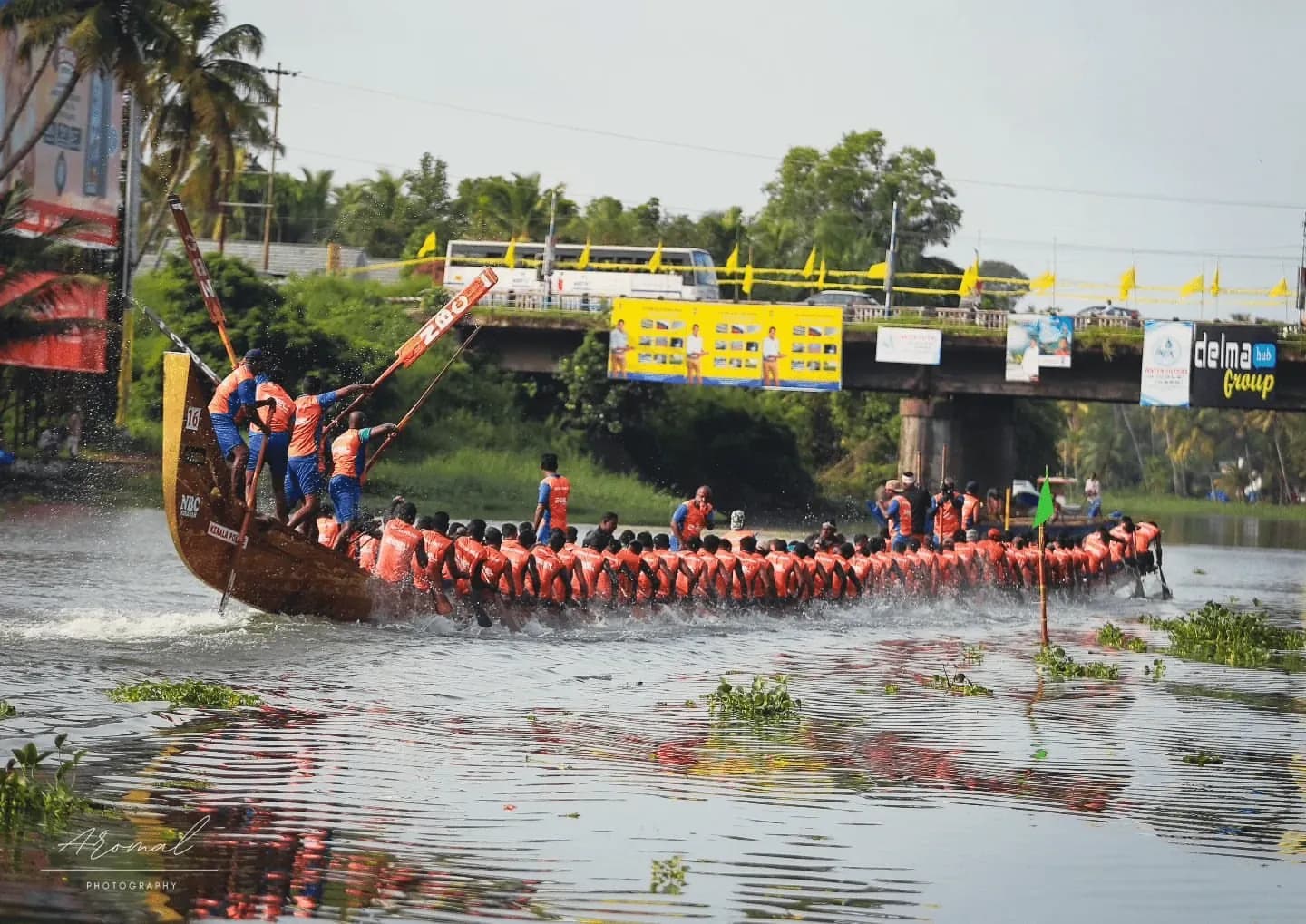 Kerala Police crew in orange racing towards the bridge