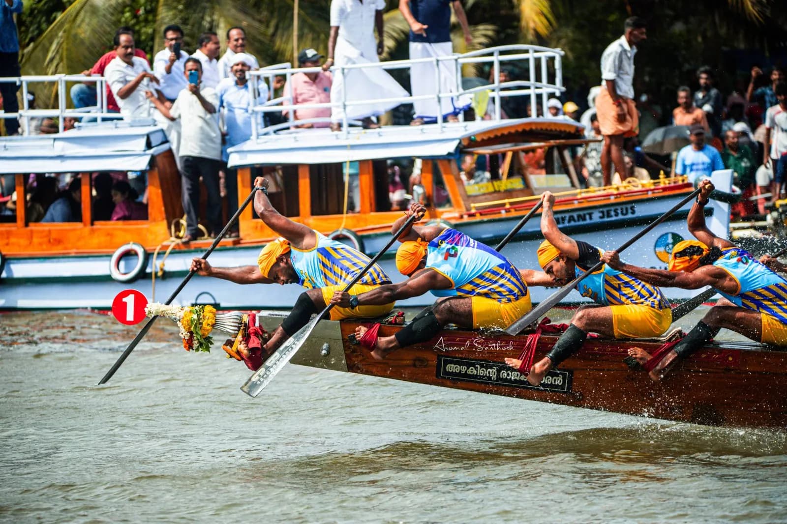PBC paddlers lunging forward from the prow of boat number one