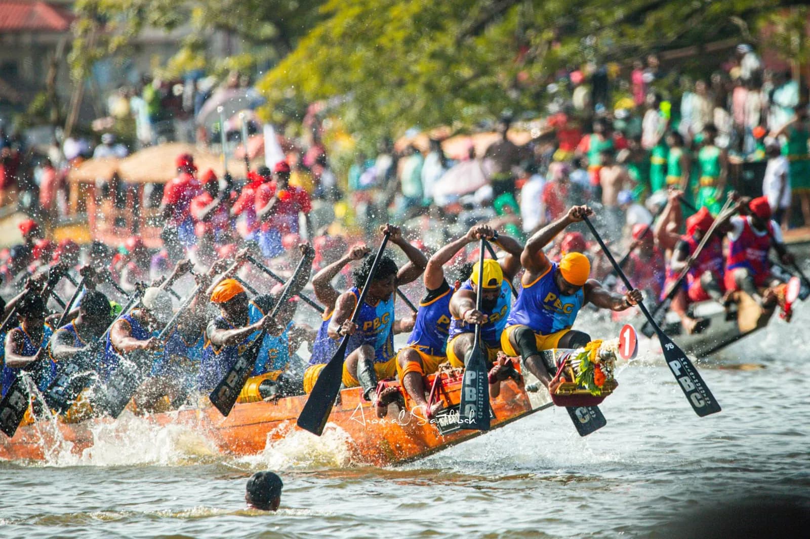 PBC crew driving through the spray ahead of a rival boat